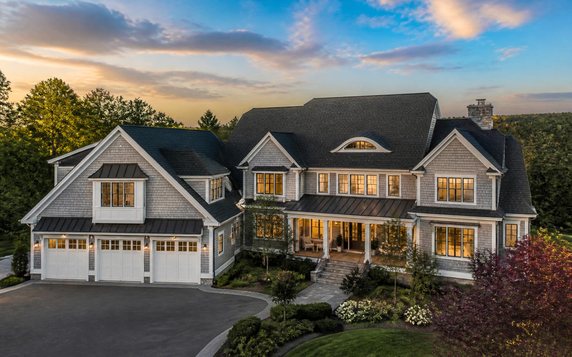 Luxury home with premium roof at sunset